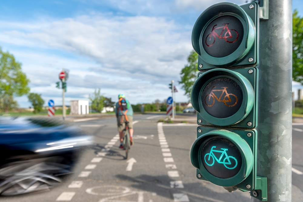 A foolish driver nearly hitting a bike in a protected crossing
