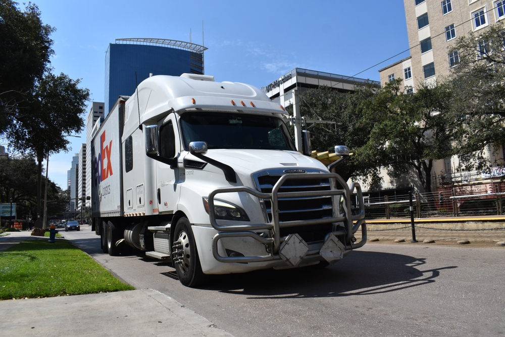 FedEx semi truck passing through city