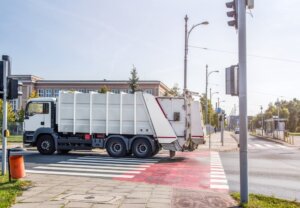 Garbage truck turning left through intersection