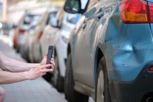 Driver records evidence of damage after car accident
