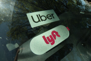 Uber and Lyft rideshare tags in a car window