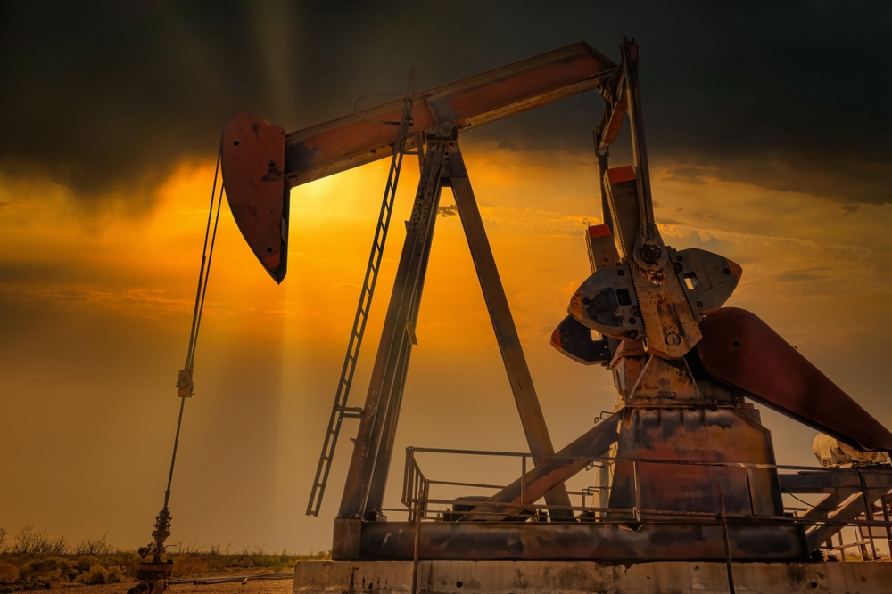 Backlit oil oil rig on Texas oilfield