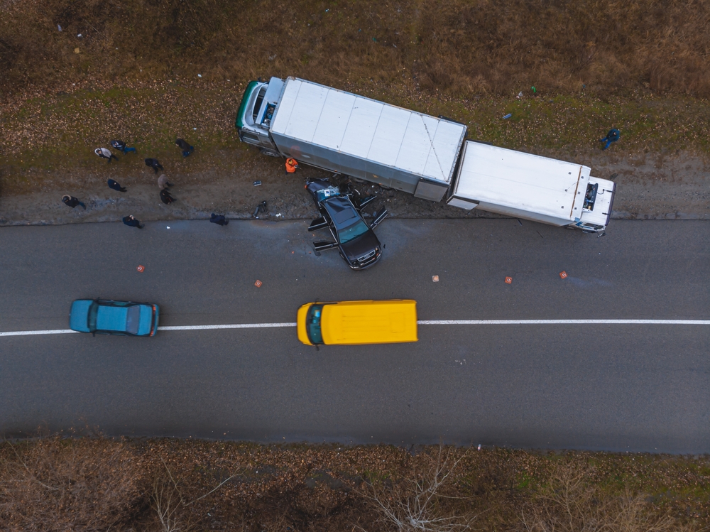 Overhead view of an underride accident between truck and car
